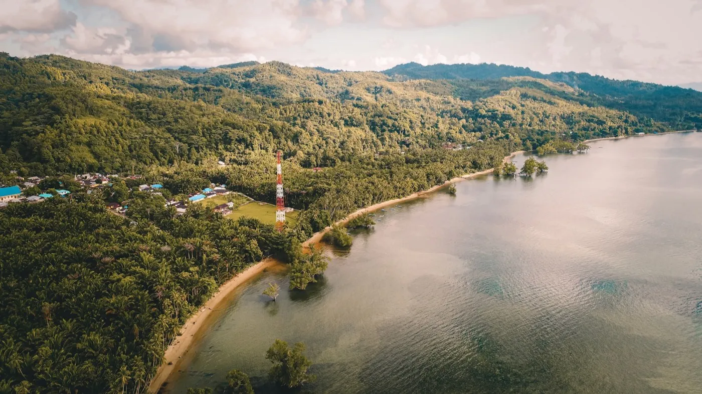 Aerial view of the Ambon coastline with a telecommunications tower